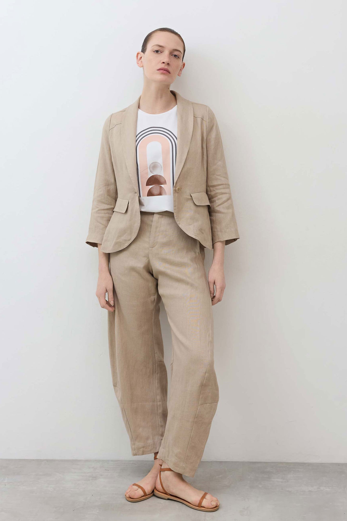 Loose linen pants in light beige with elastic waistband and relaxed straight-leg silhouette