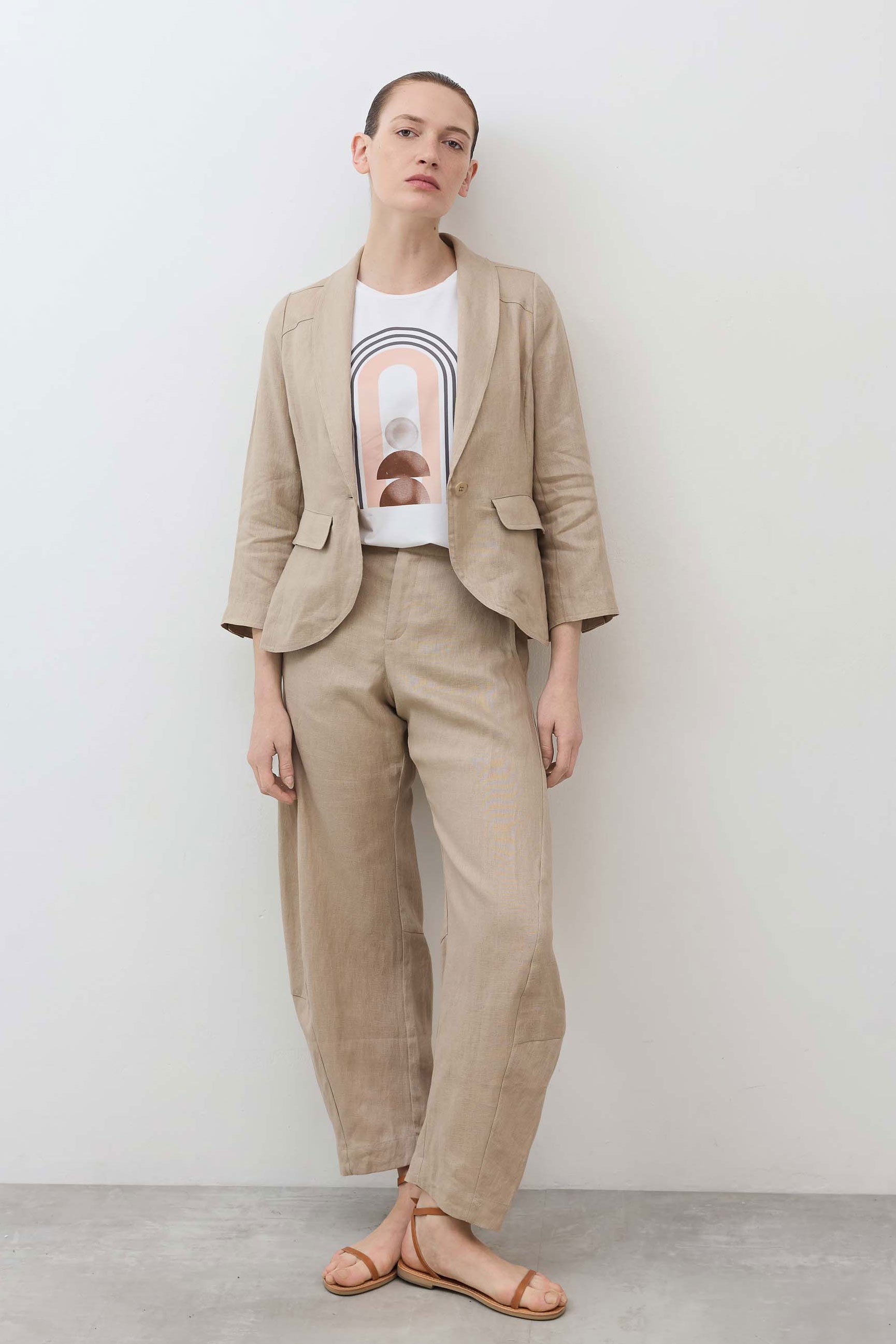 Loose linen pants in light beige with elastic waistband and relaxed straight-leg silhouette