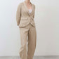 Light beige linen pants, relaxed leg shape, elastic waistband and ankle-length hem