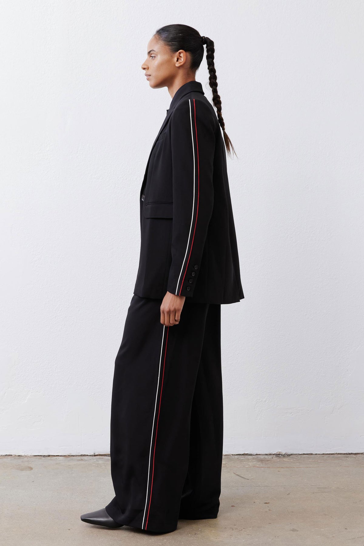 Black blazer long silhouette with red stripe piping on front and sleeve