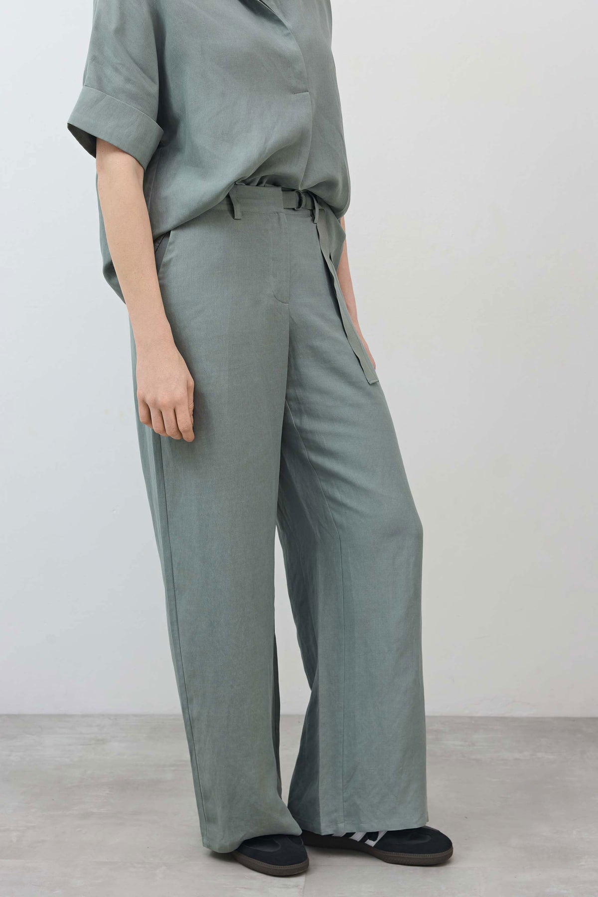 Chinois green wide-leg trousers, belted waist with side tie and relaxed long legs