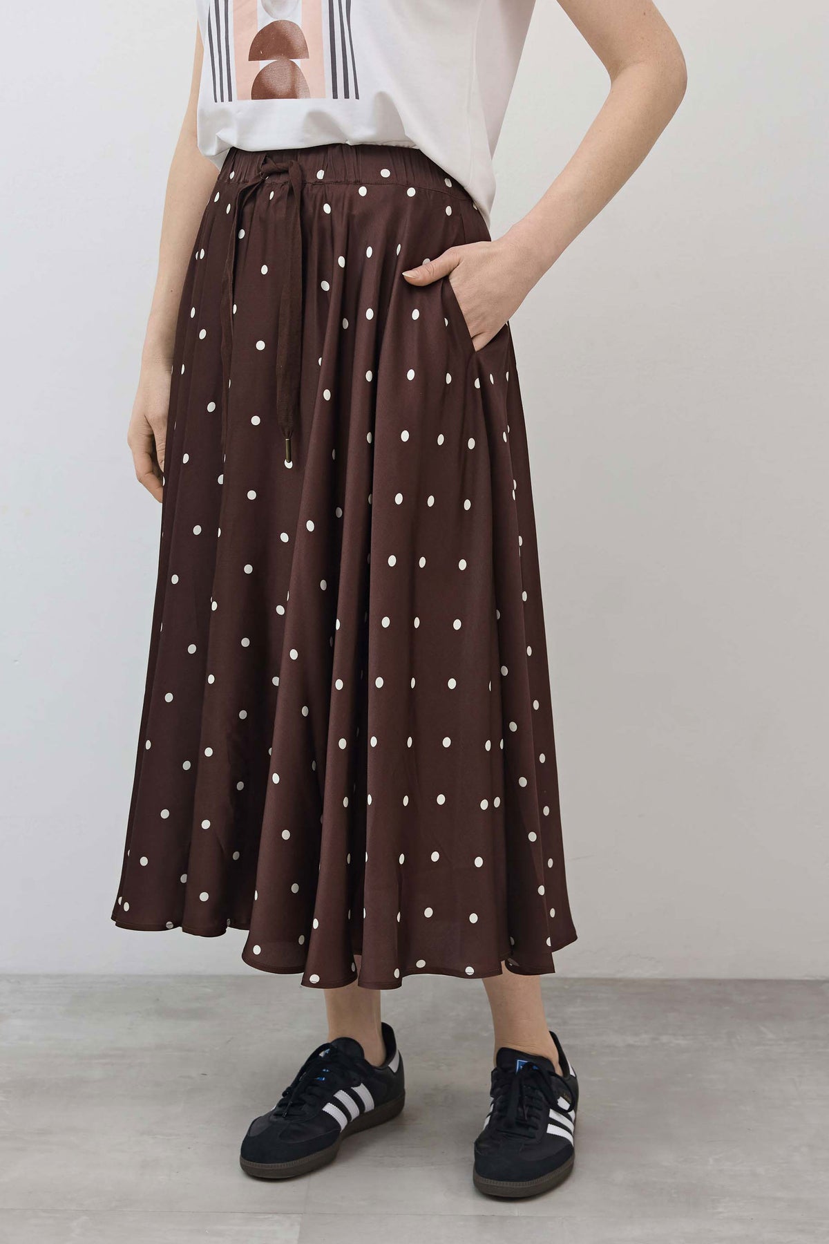 Brown maxi skirt with white polka dots, full pleated silhouette