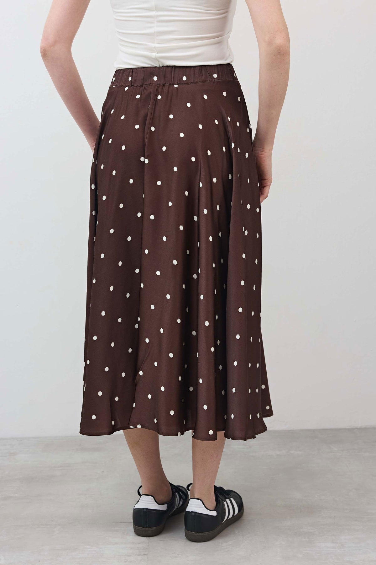 Brown pleated midi-to-maxi skirt with white polka dots and elastic waist