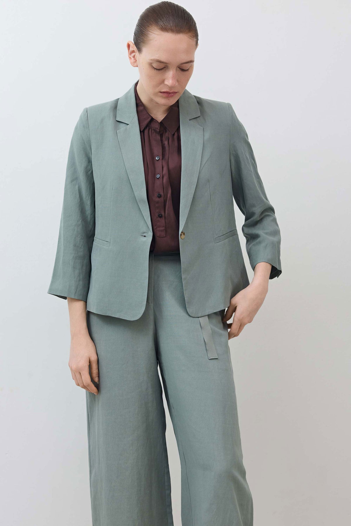 Chinois green shrunken blazer on model, notch lapel, button front, patch pockets