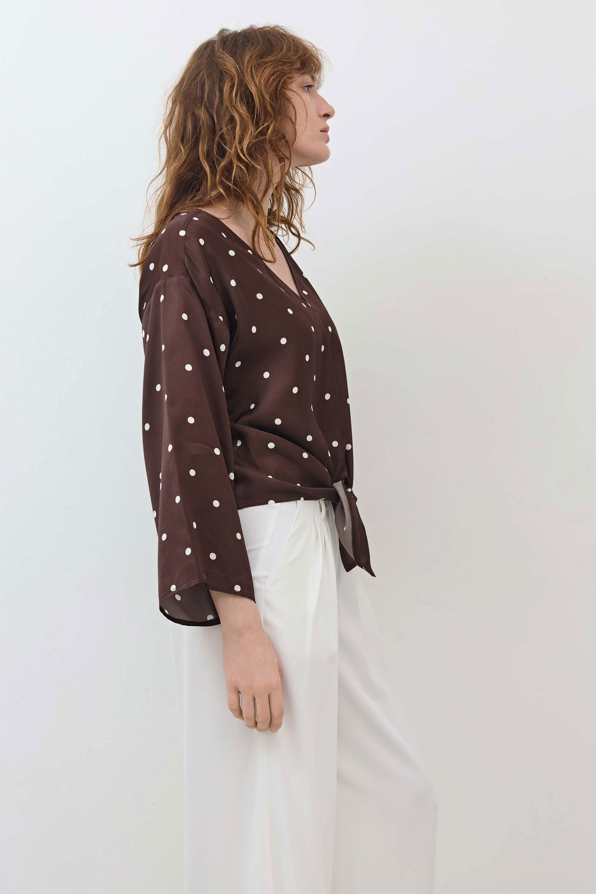 Silky tie-front blouse in brown with white polka dots, V-neck and side view with bow