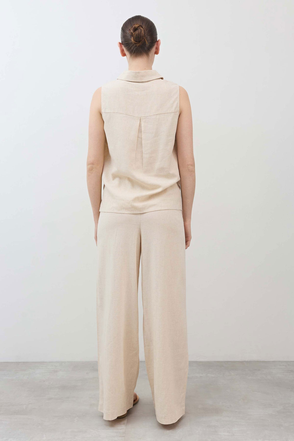 Oatmeal sleeveless button-down top with back yoke and full-length drape