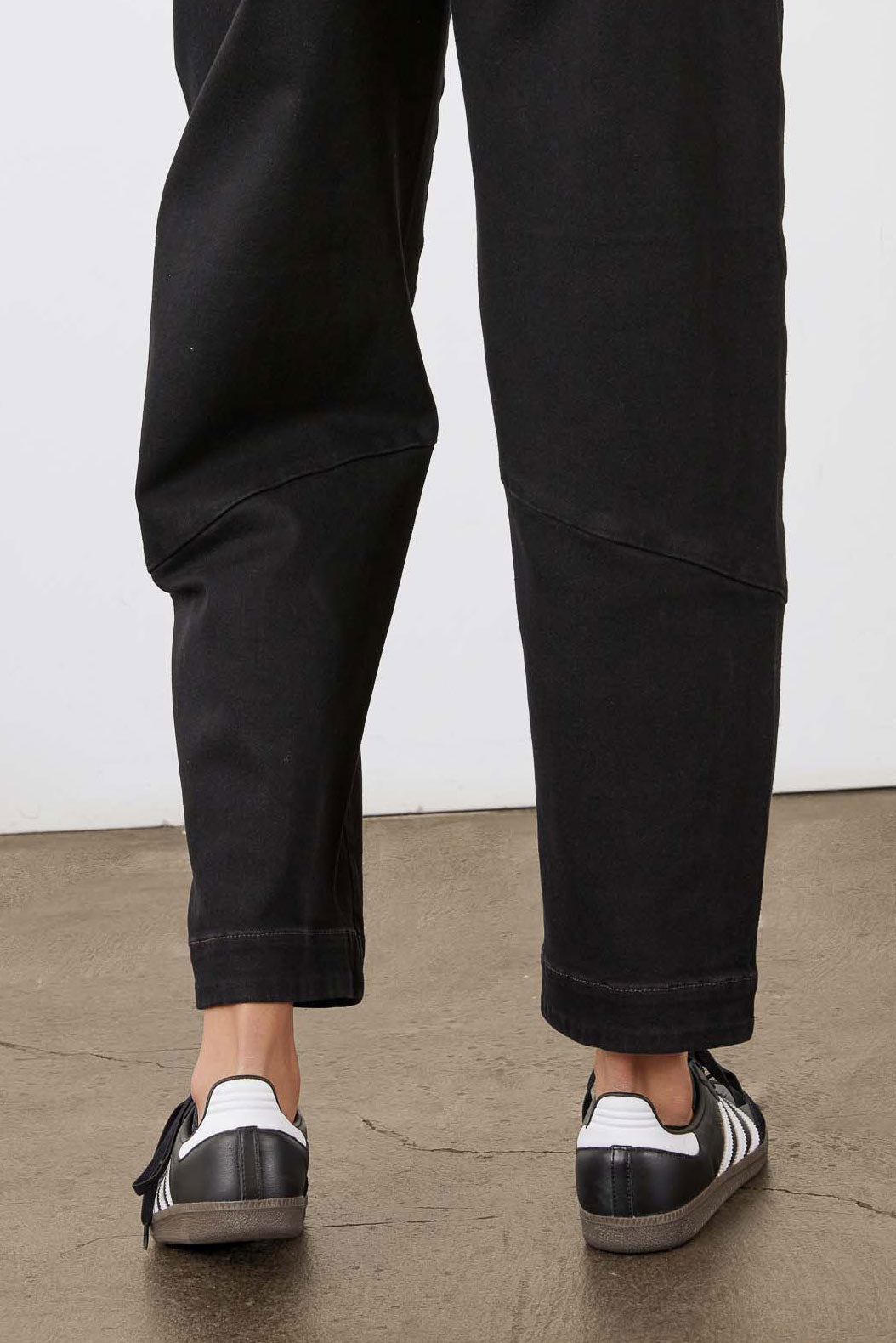 Black slouchy jeans, cropped hem with contrast topstitching and side panel seam