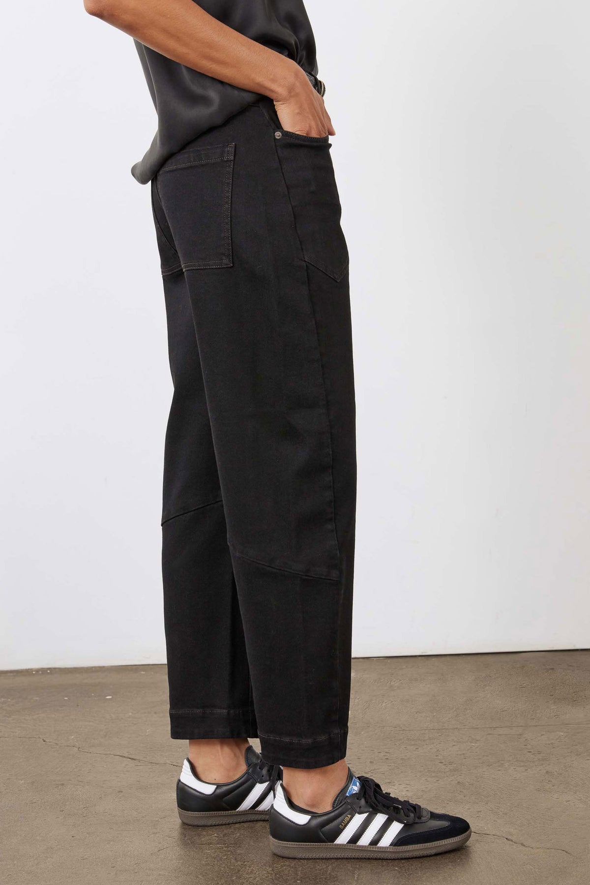 Black slouchy jeans with side cargo pocket and cuffed cropped hem