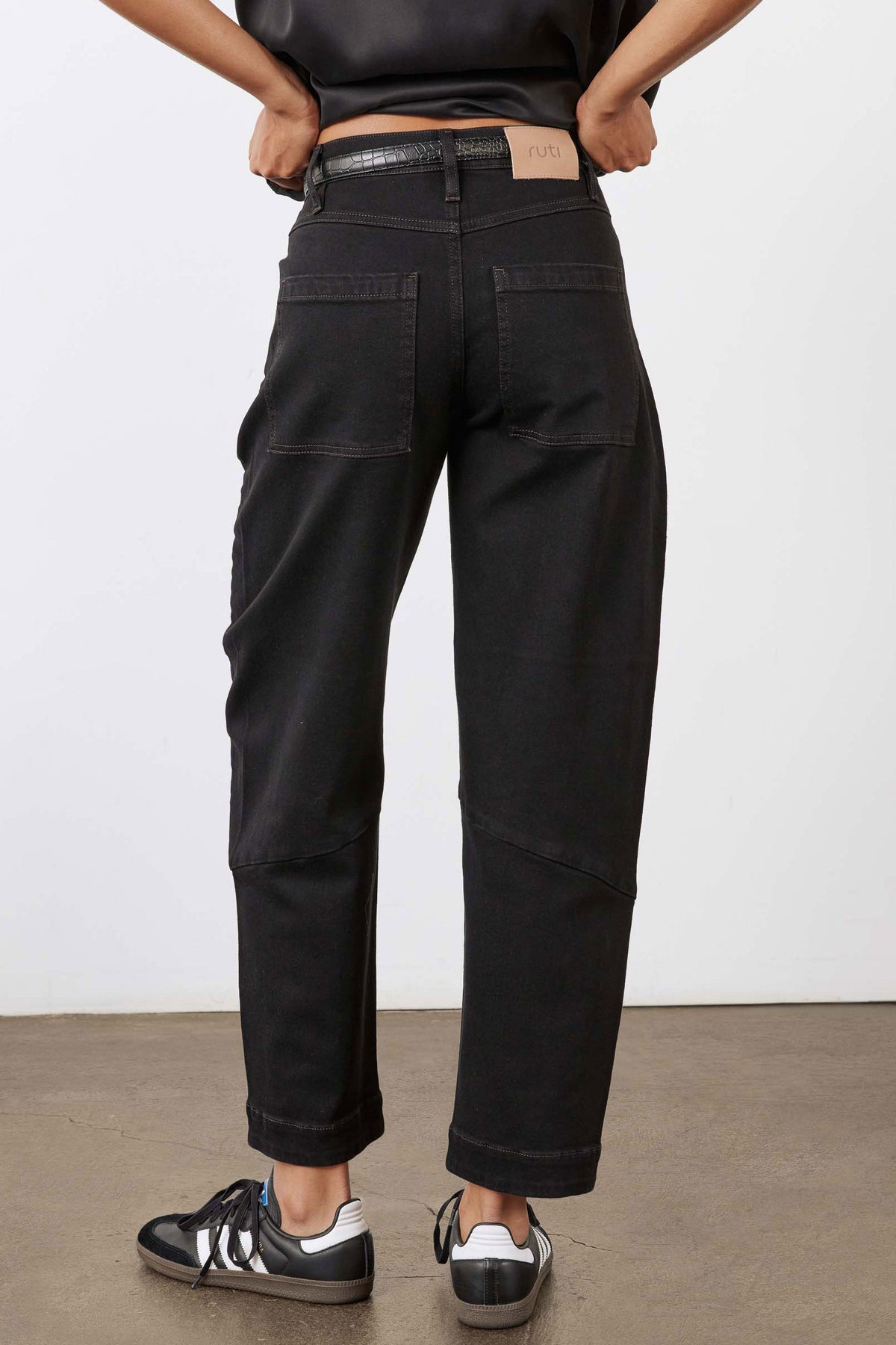 Black slouchy jeans with cargo-style front pockets and tapered cuffs