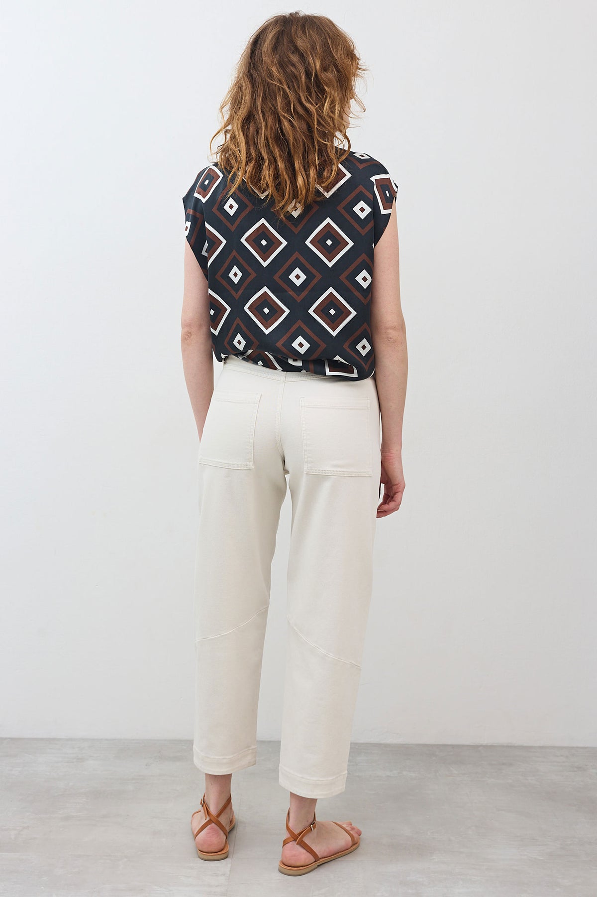 Vintage white wash slouchy jeans from the back with relaxed straight legs and pockets