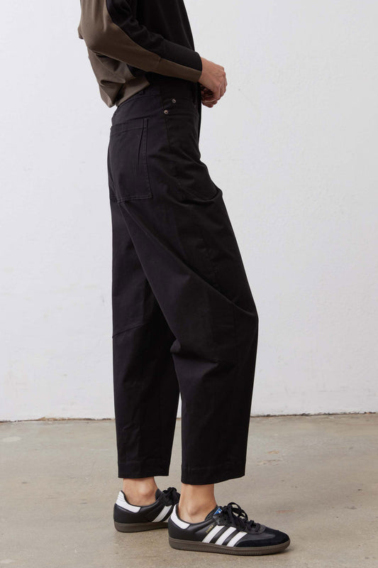 Black slouchy twill pants with cargo-style side pockets and cuffed ankle hem