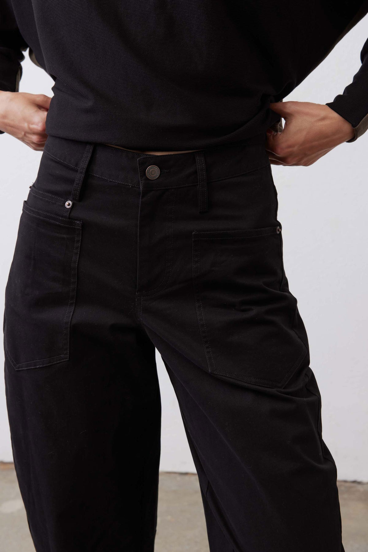 Black slouchy twill pants, zip fly with snap/button closure and side cargo pocket