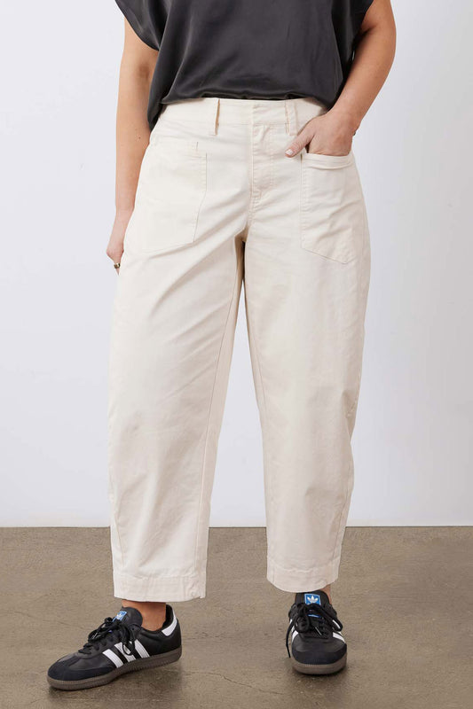 Ecru slouchy twill pants with relaxed straight legs and cargo pocket details.