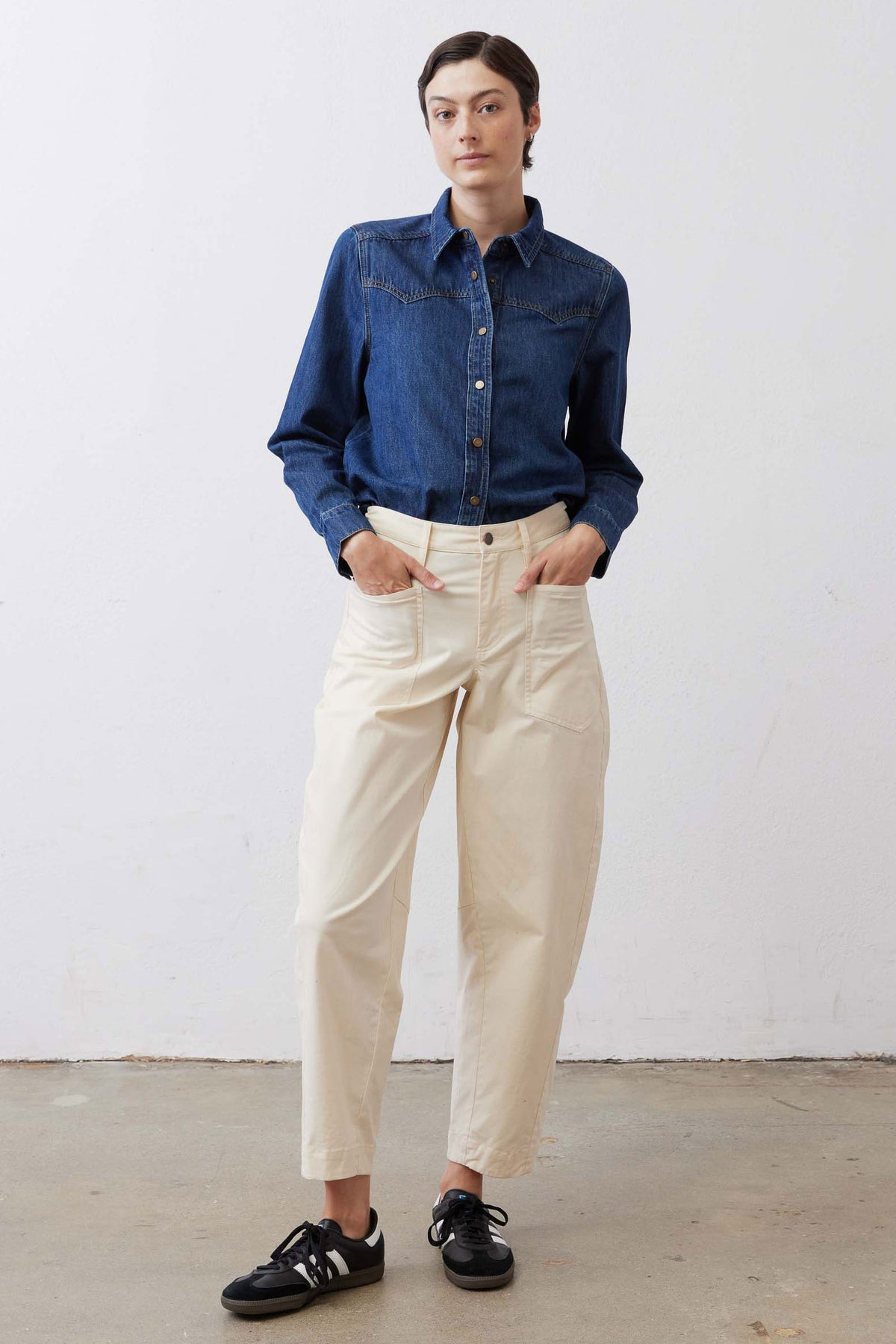 Ecru relaxed twill pants with belt loops, button fly, and tapered ankle length