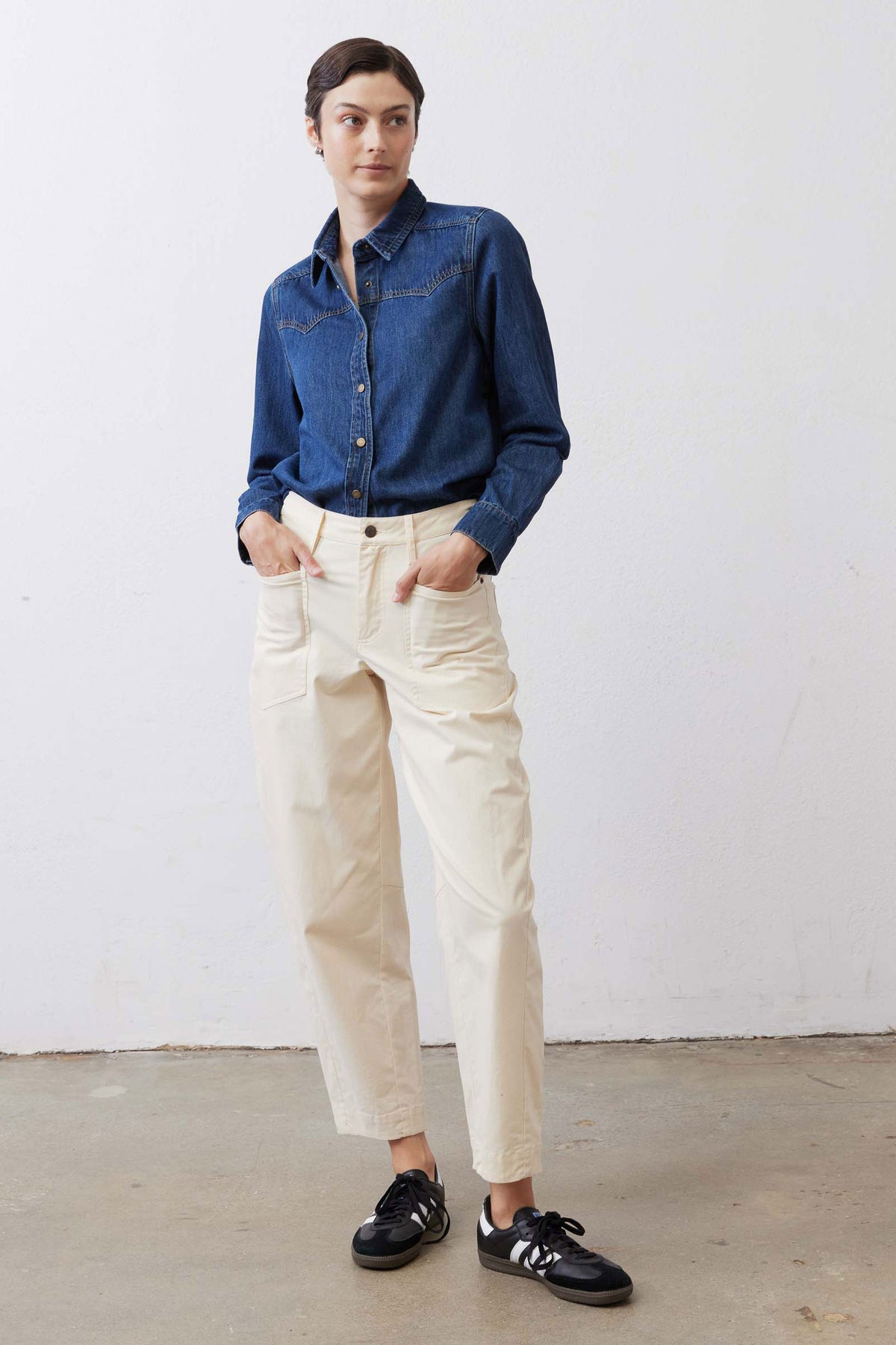 Ecru twill pants featuring button front, belt loops, and side pockets