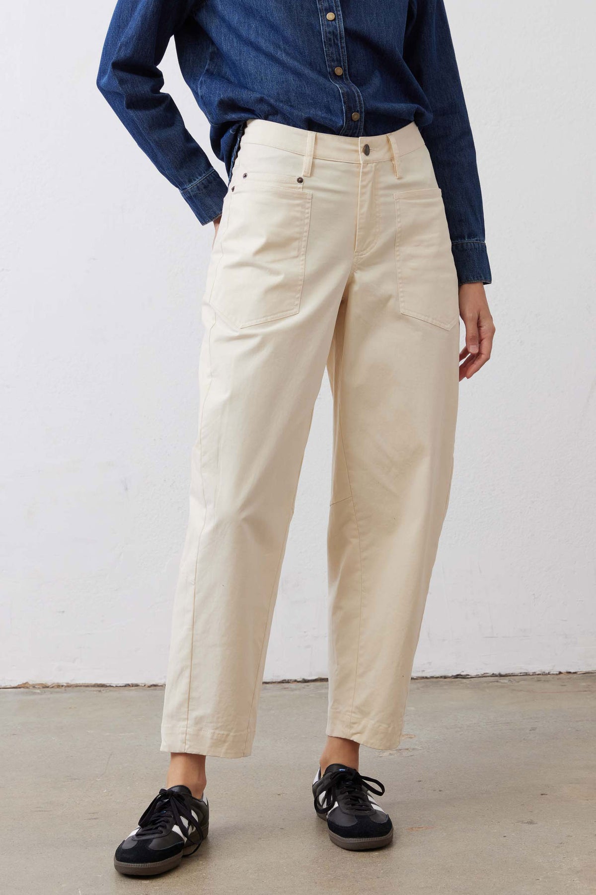 Ecru slouchy twill pants with belt loops, button front, and cuffed ankle hem