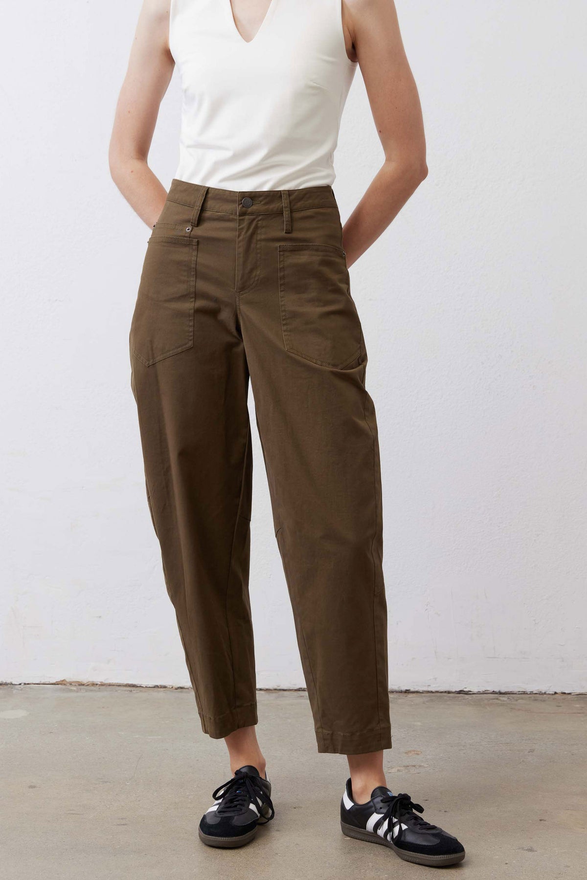 Olive slouchy twill pants with front button, belt loops, and straight relaxed leg.