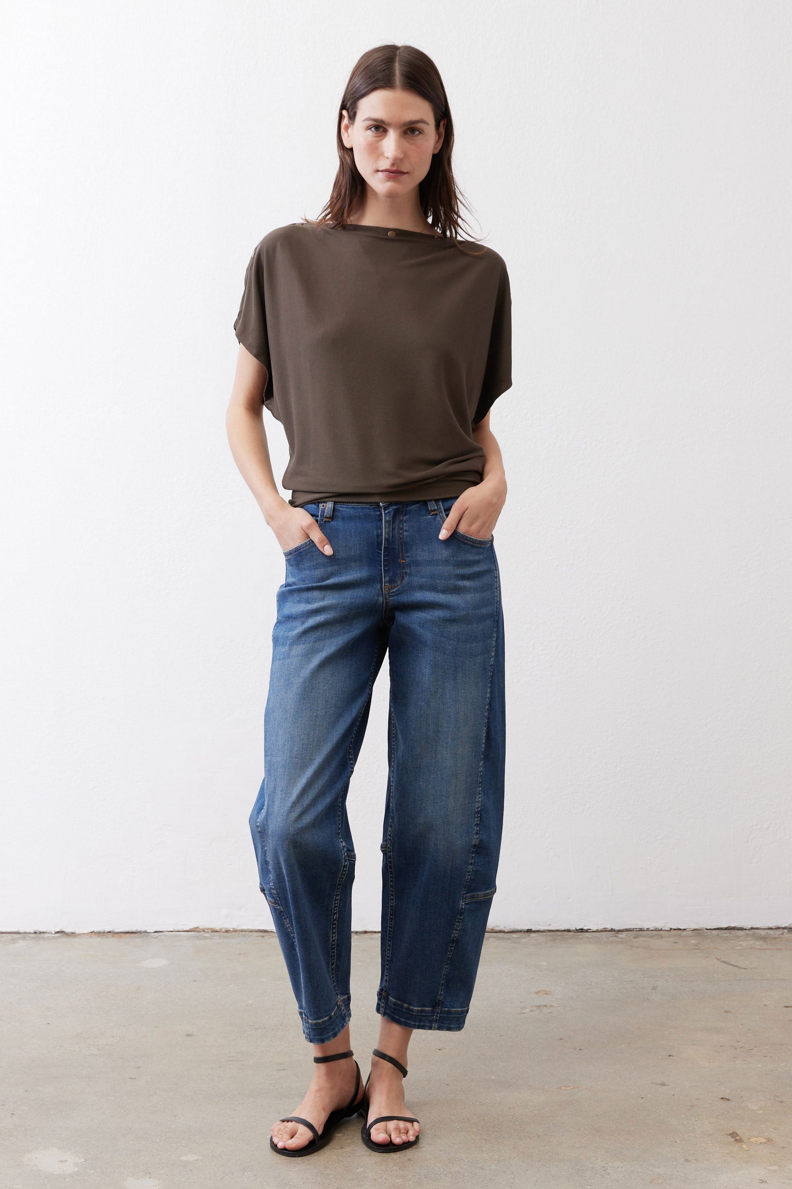 Olive short sleeve top with loose fit and round neck, side view