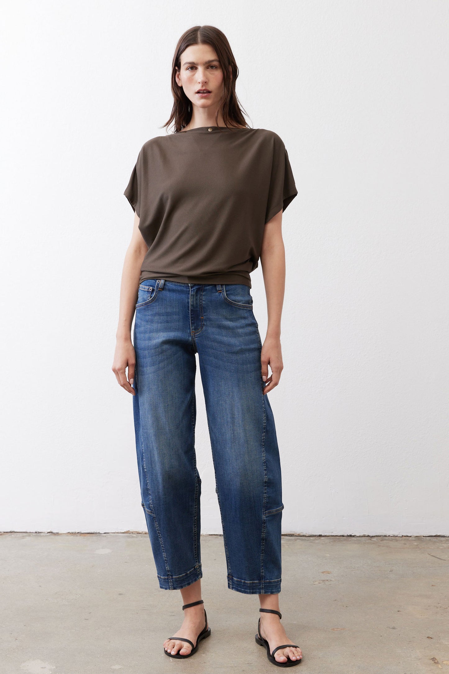 Olive short sleeve top with loose drape and crew neck, front view