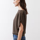 Olive short sleeve top with draped fabric and relaxed side silhouette