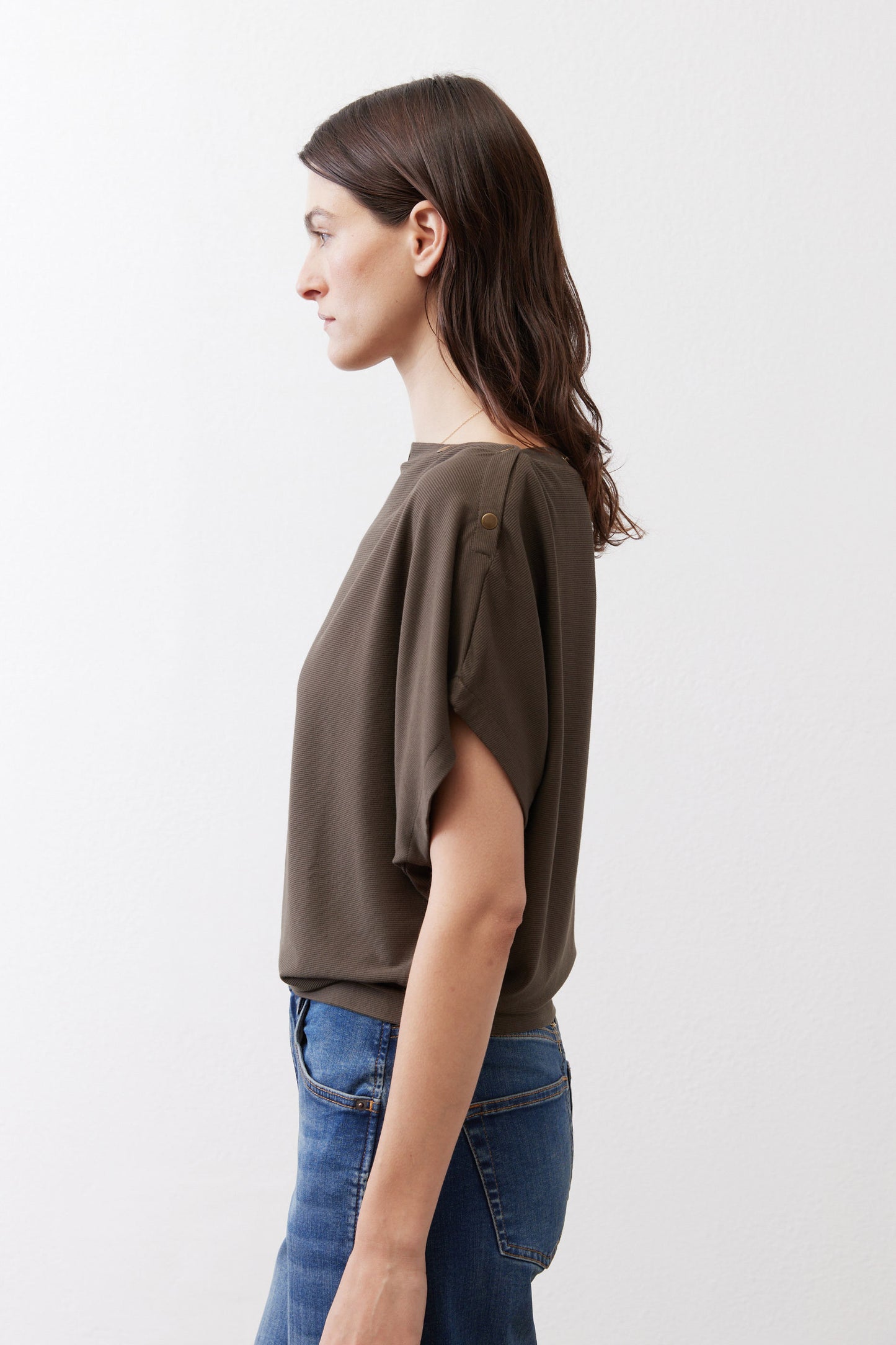 Olive short sleeve top with draped fabric and relaxed side silhouette