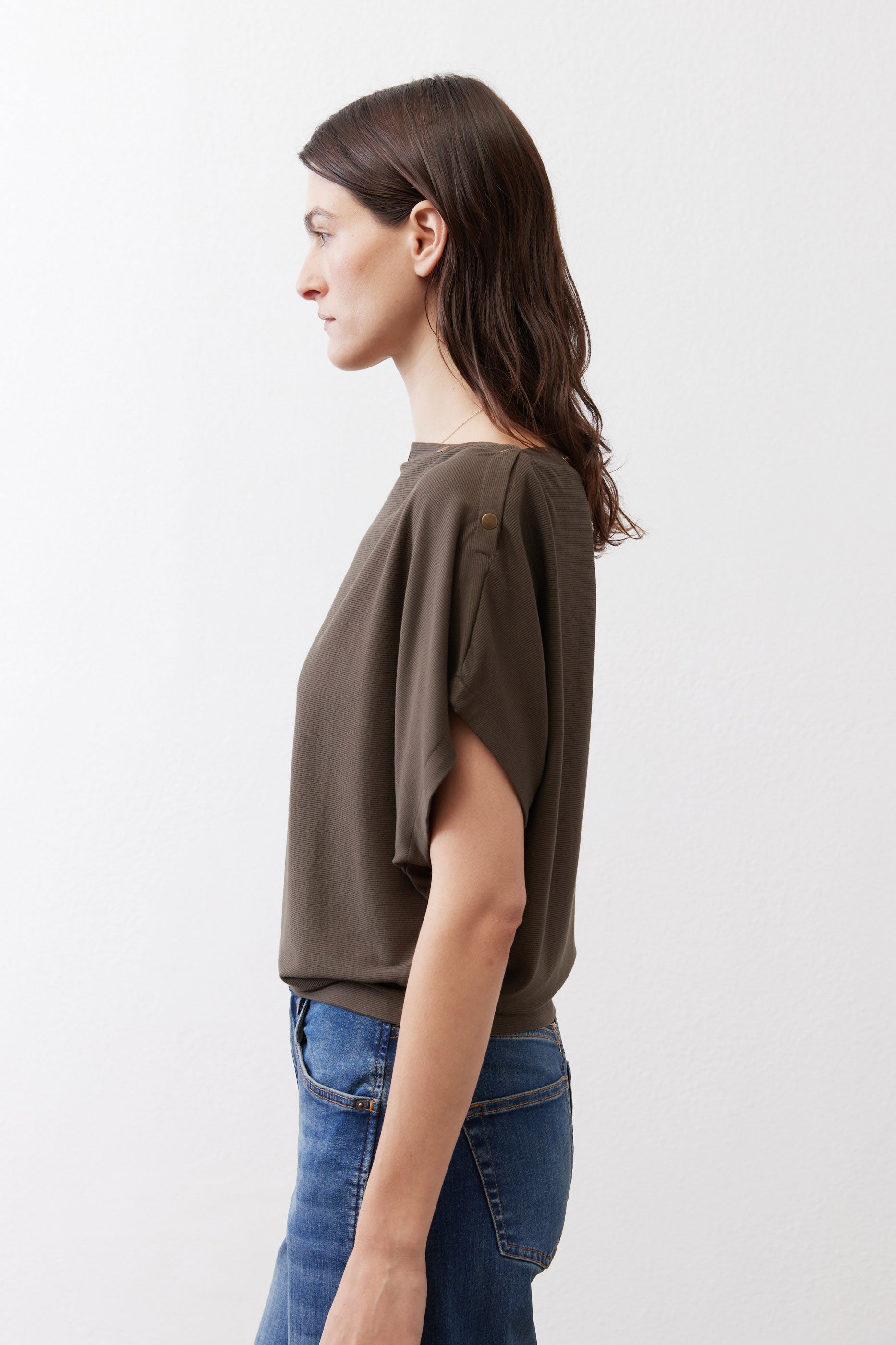 Olive short sleeve top with draped fabric and relaxed side silhouette