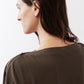 Olive short sleeve top back with two-button neck closure, close-up