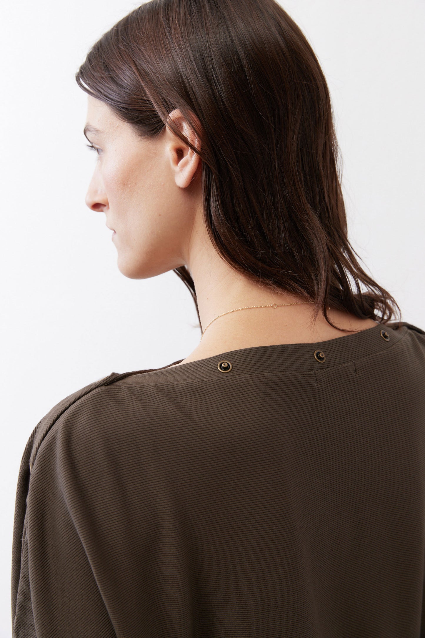 Olive short sleeve top back with two-button neck closure, close-up