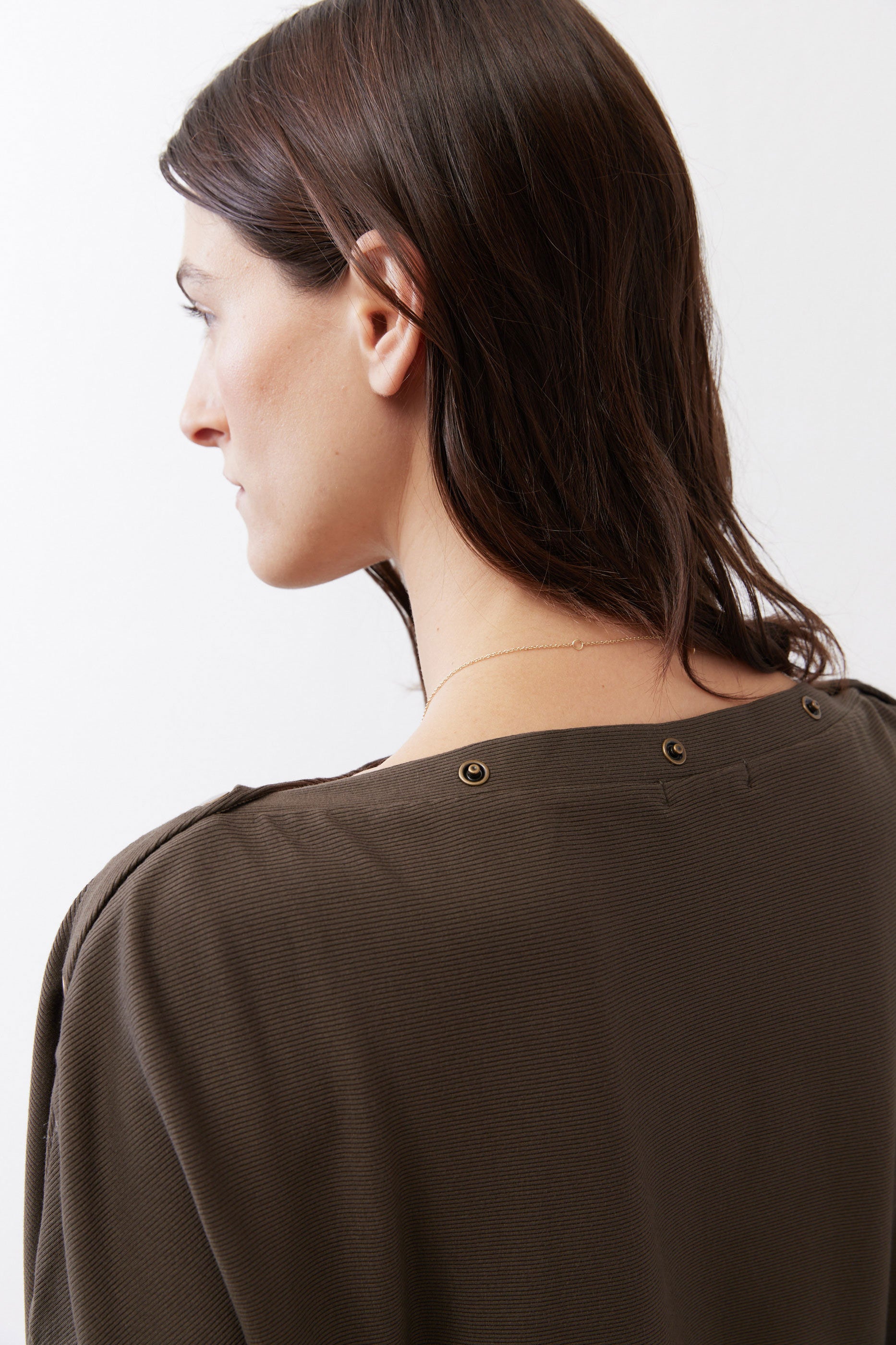 Olive short sleeve top back with two-button neck closure, close-up