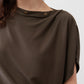 Olive short sleeve top with two-button neck detail, close-up