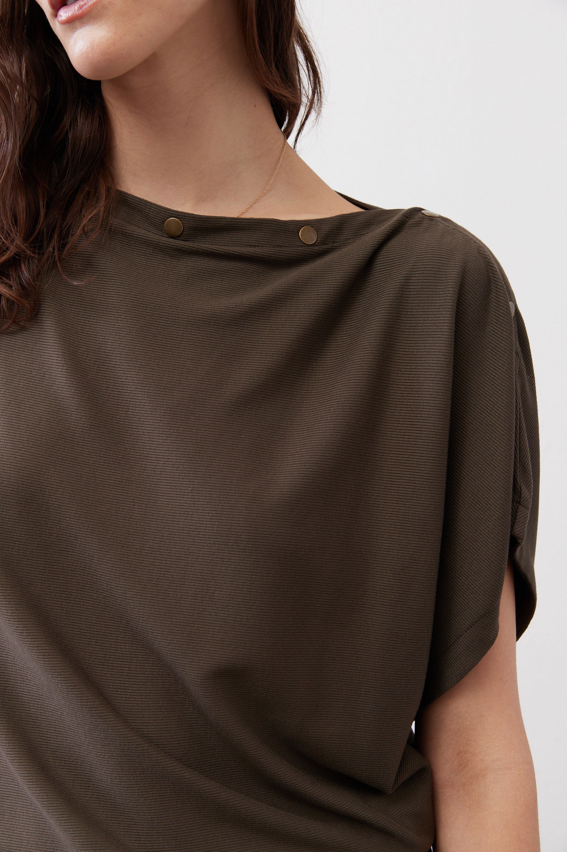 Olive short sleeve top with two-button neck detail, close-up