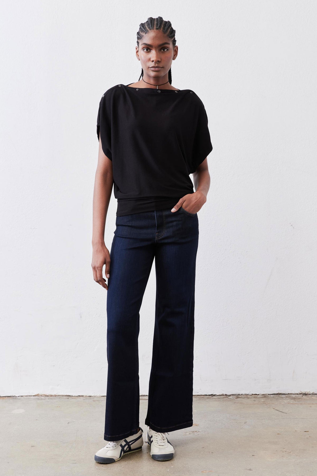 Black short-sleeve top with crew neck and slightly draped hem