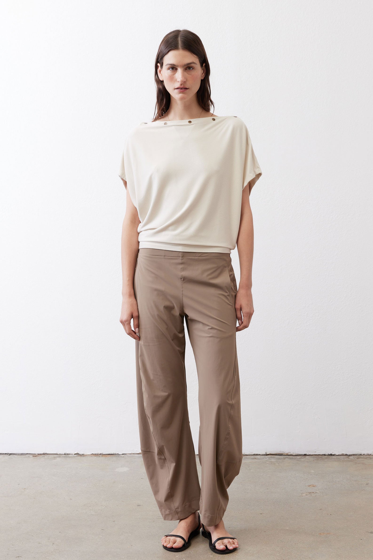 Cream short-sleeve draped top with button detail at the neckline