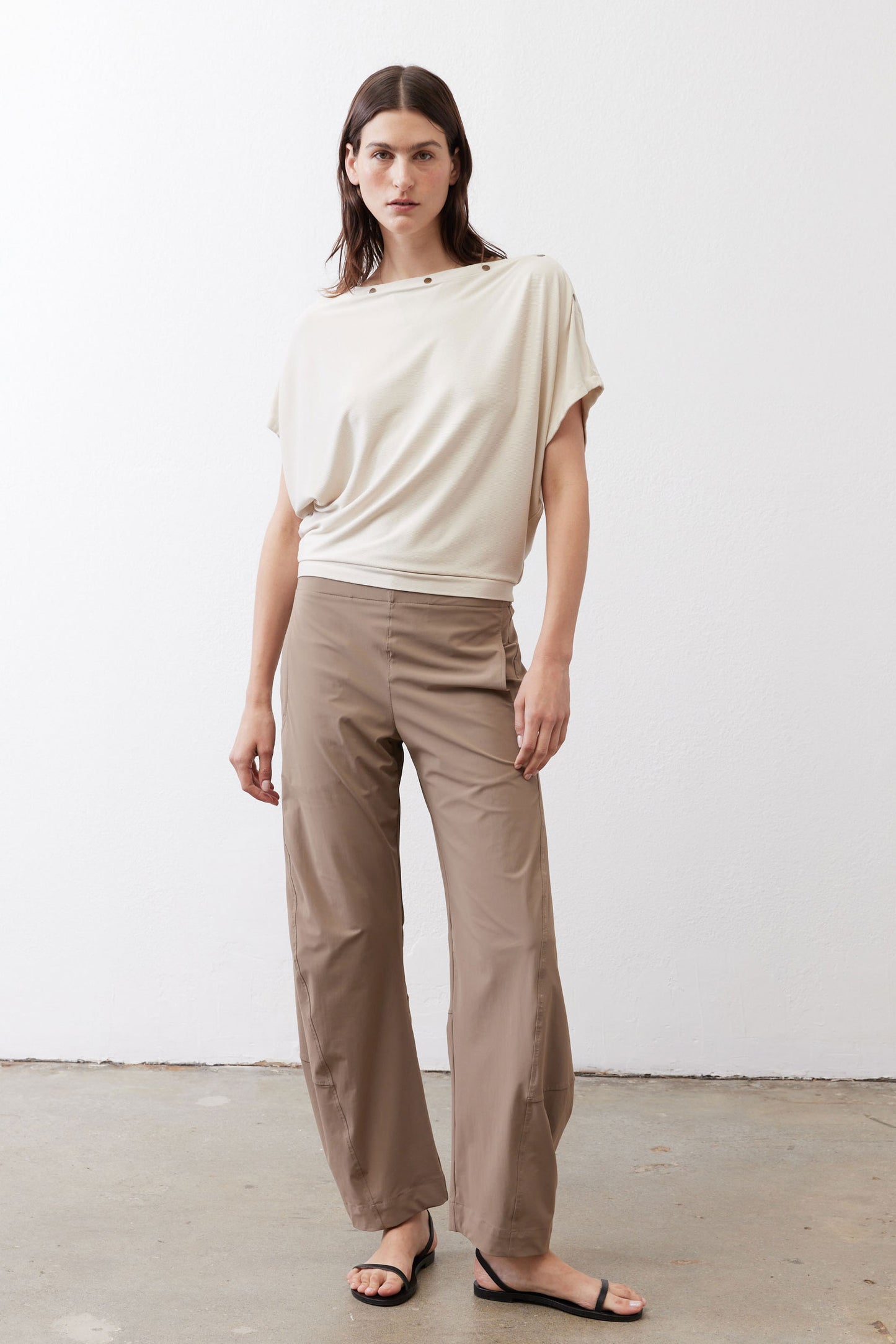 Cream short-sleeve draped top with buttoned neckline and relaxed hem