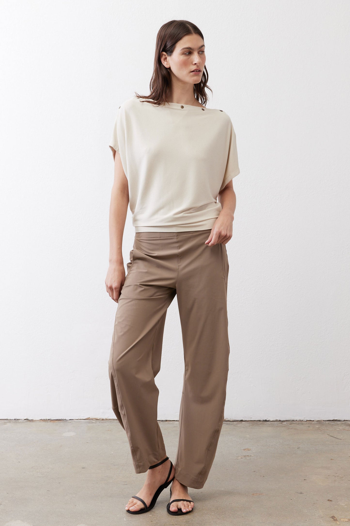 Cream short-sleeve top with draped fit and buttoned neckline