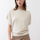 Cream short-sleeve top with round neckline and snap-button shoulder detail
