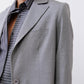 Gray melange blazer close-up of square lapel and chest flap pocket with button