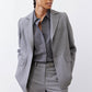 Gray melange squared off blazer with square lapel and flap pockets, worn open