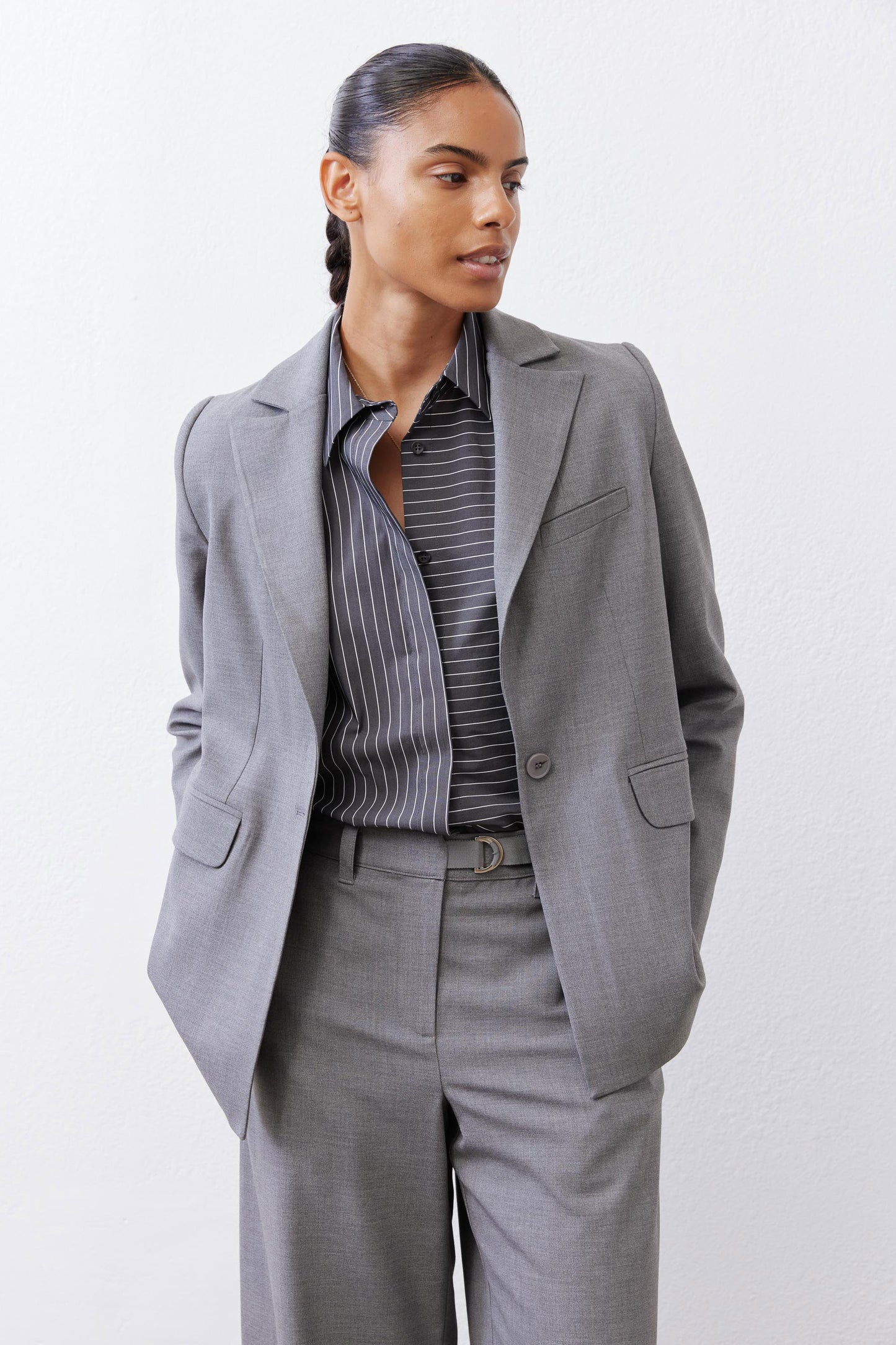 Gray melange squared off blazer with square lapel and flap pockets, worn open
