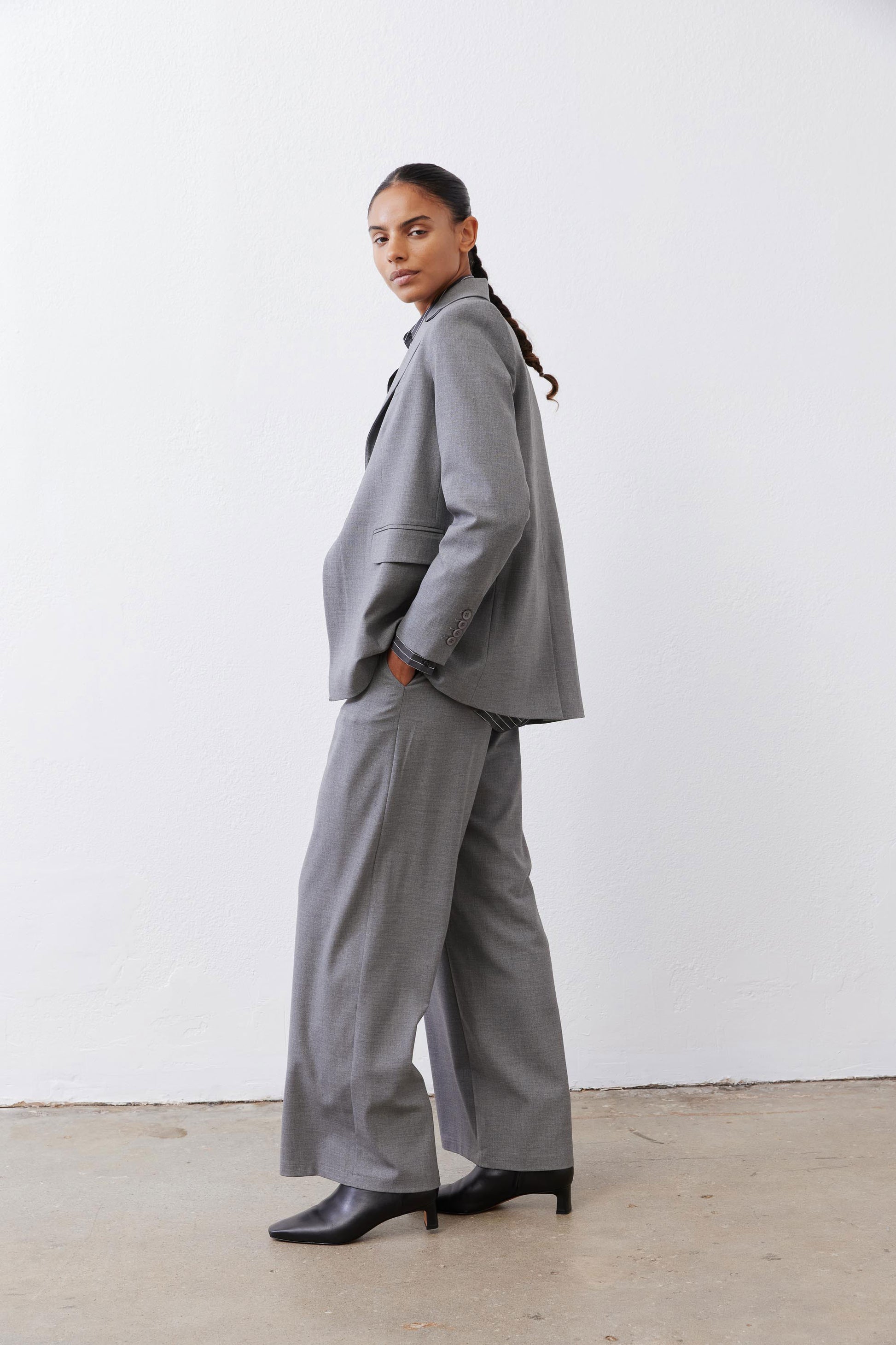 Gray melange squared off blazer side view with square lapel and flap pocket