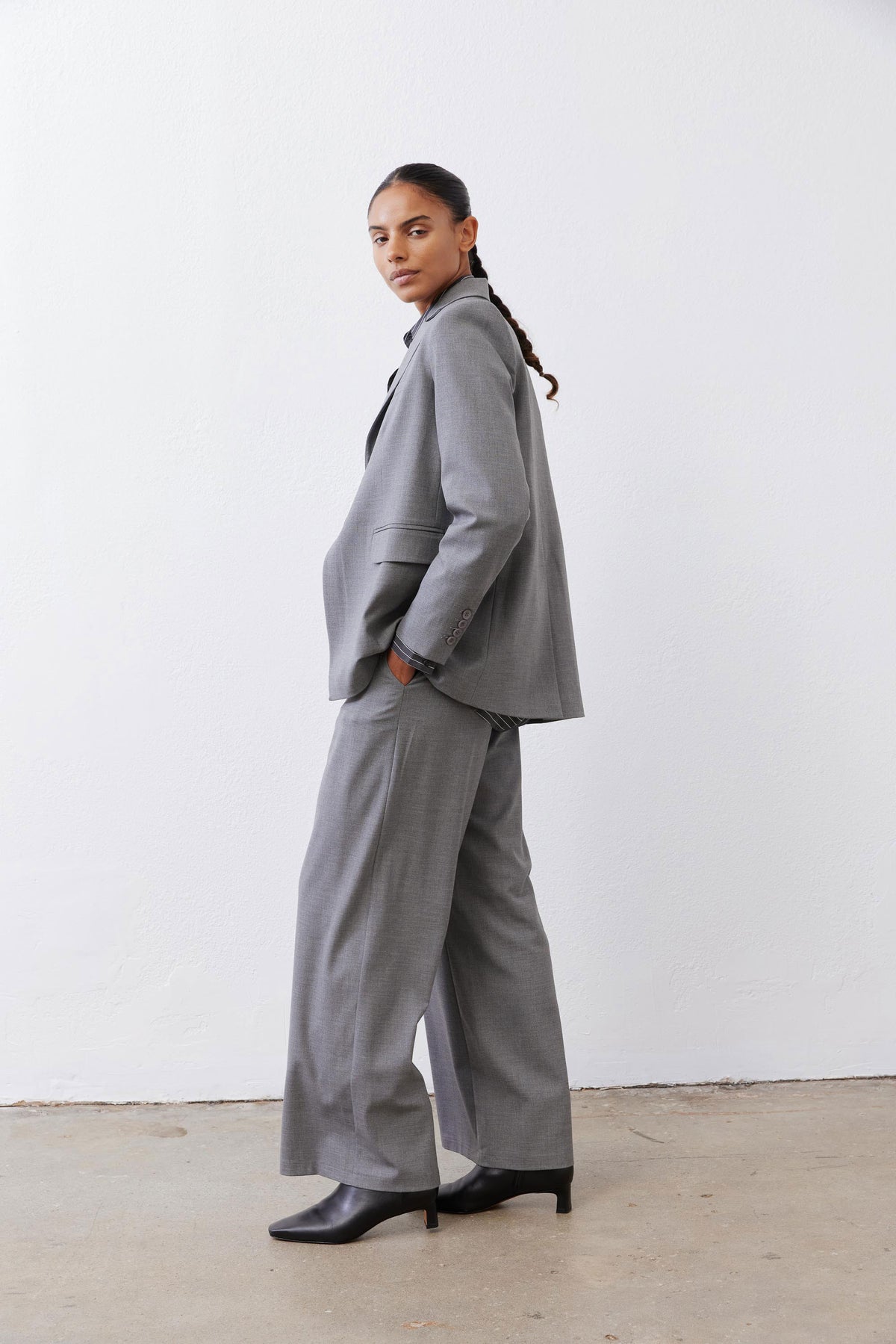 Gray melange squared off blazer side view with square lapel and flap pocket
