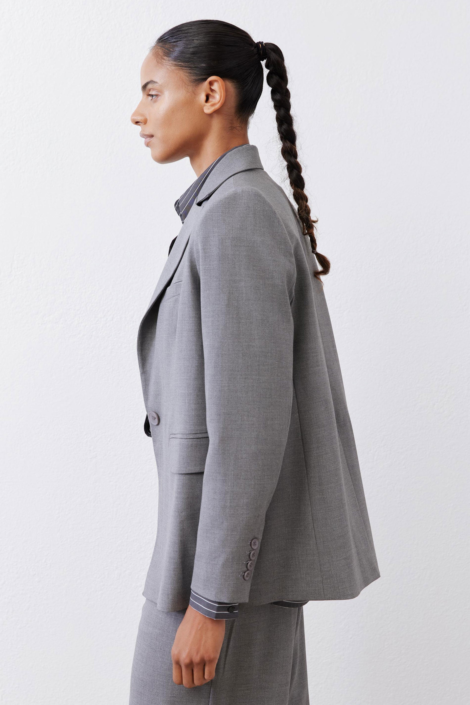 Gray melange blazer back view with squared shoulders and single-button cuff