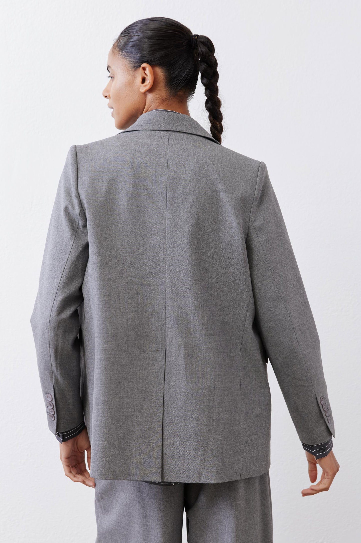 Gray melange blazer back view with center seam and two-button cuff