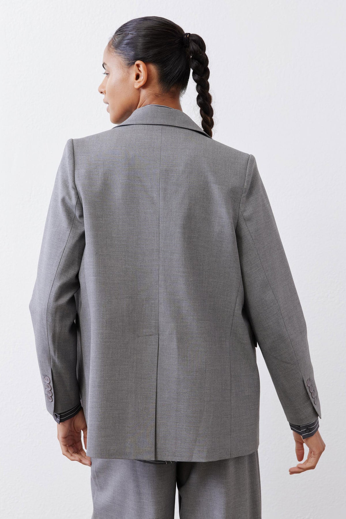 Gray melange blazer back view with center seam and two-button cuff