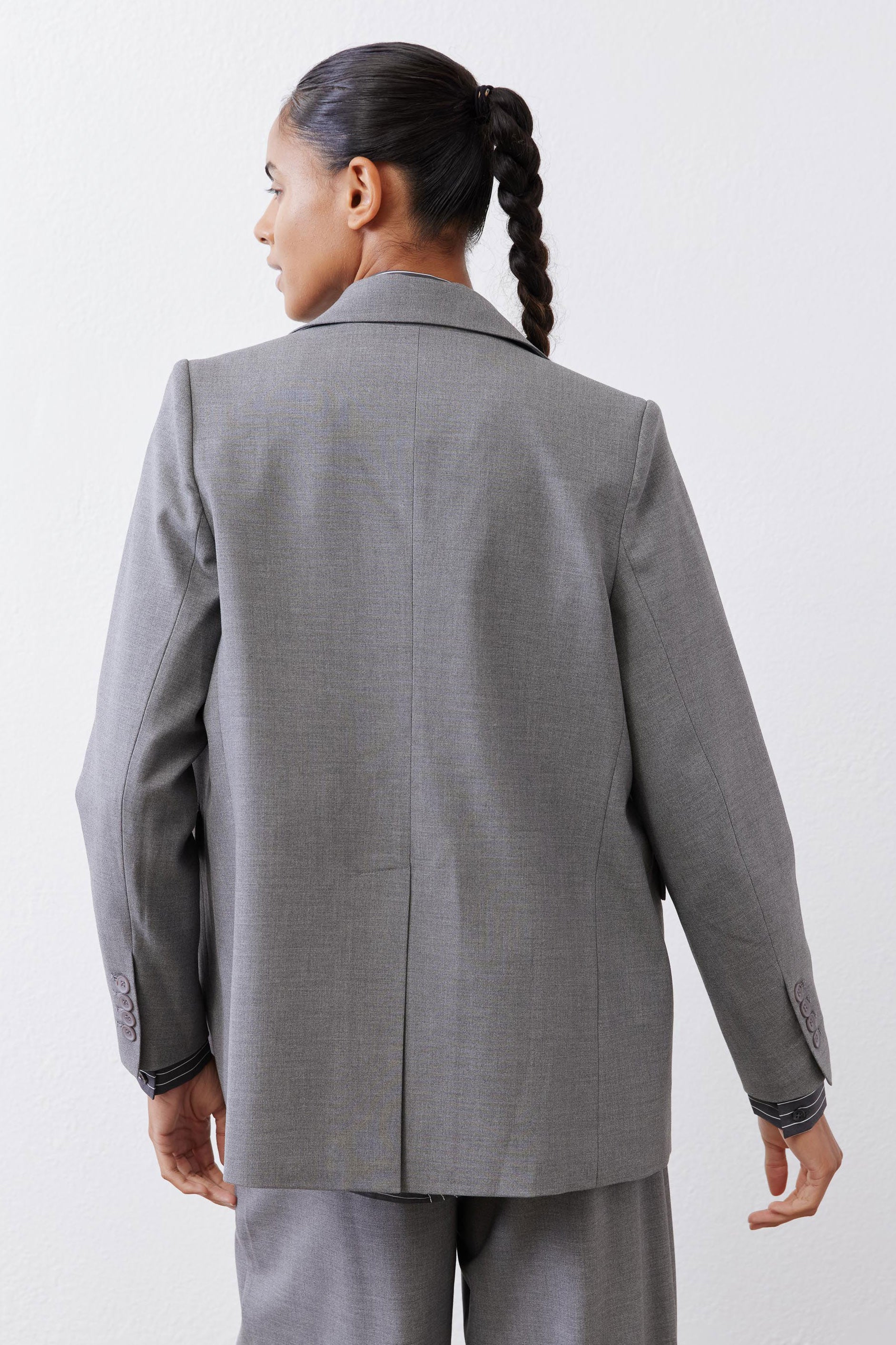 Gray melange blazer back view with center seam and two-button cuff