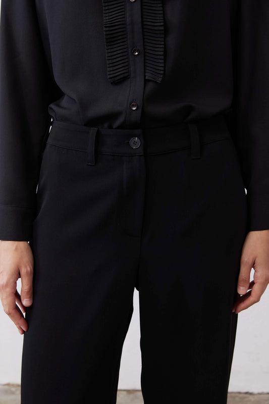 Black straight-leg pants front with button closure and flap pockets
