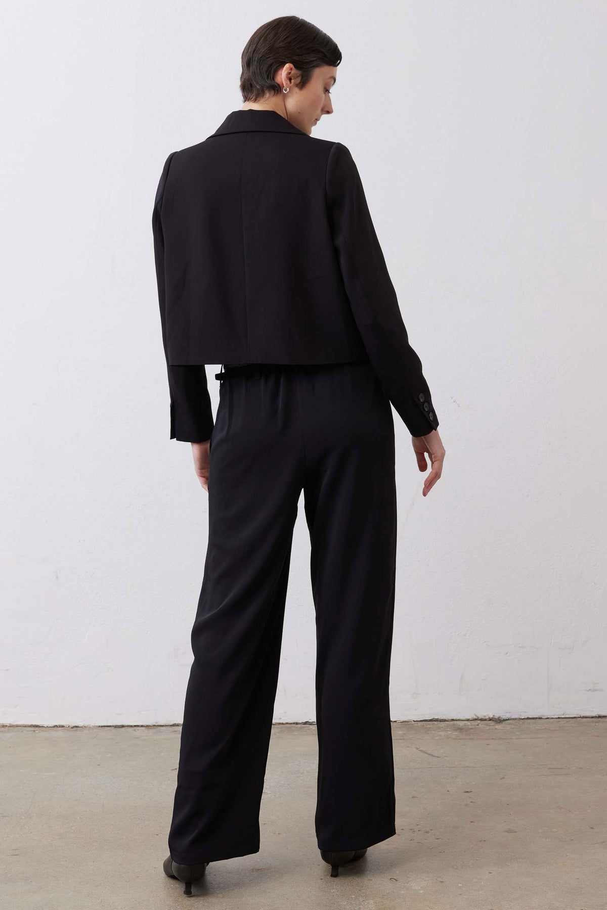Black straight-leg pants back view with center seam and straight legs