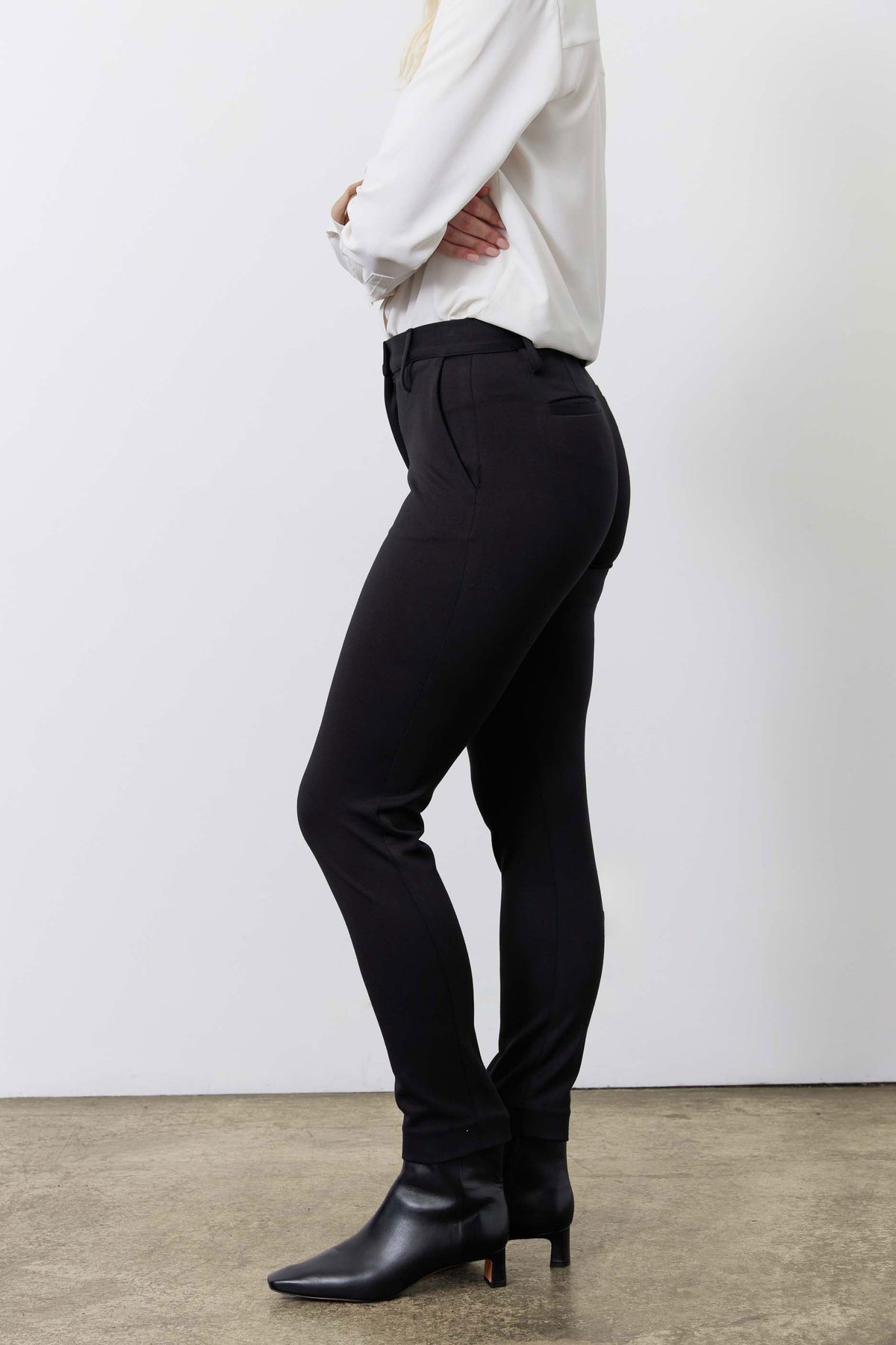 Black tapered suit pants side view with slim fit and ankle-length hem