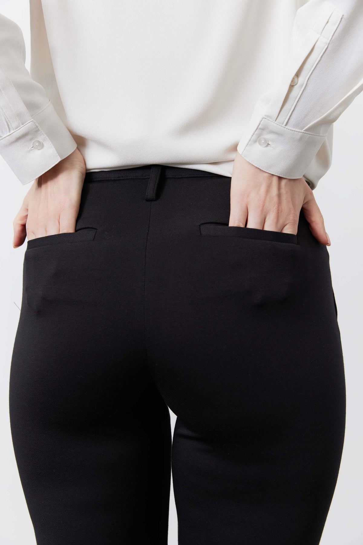 Black tapered suit pants waistband and front pocket close-up