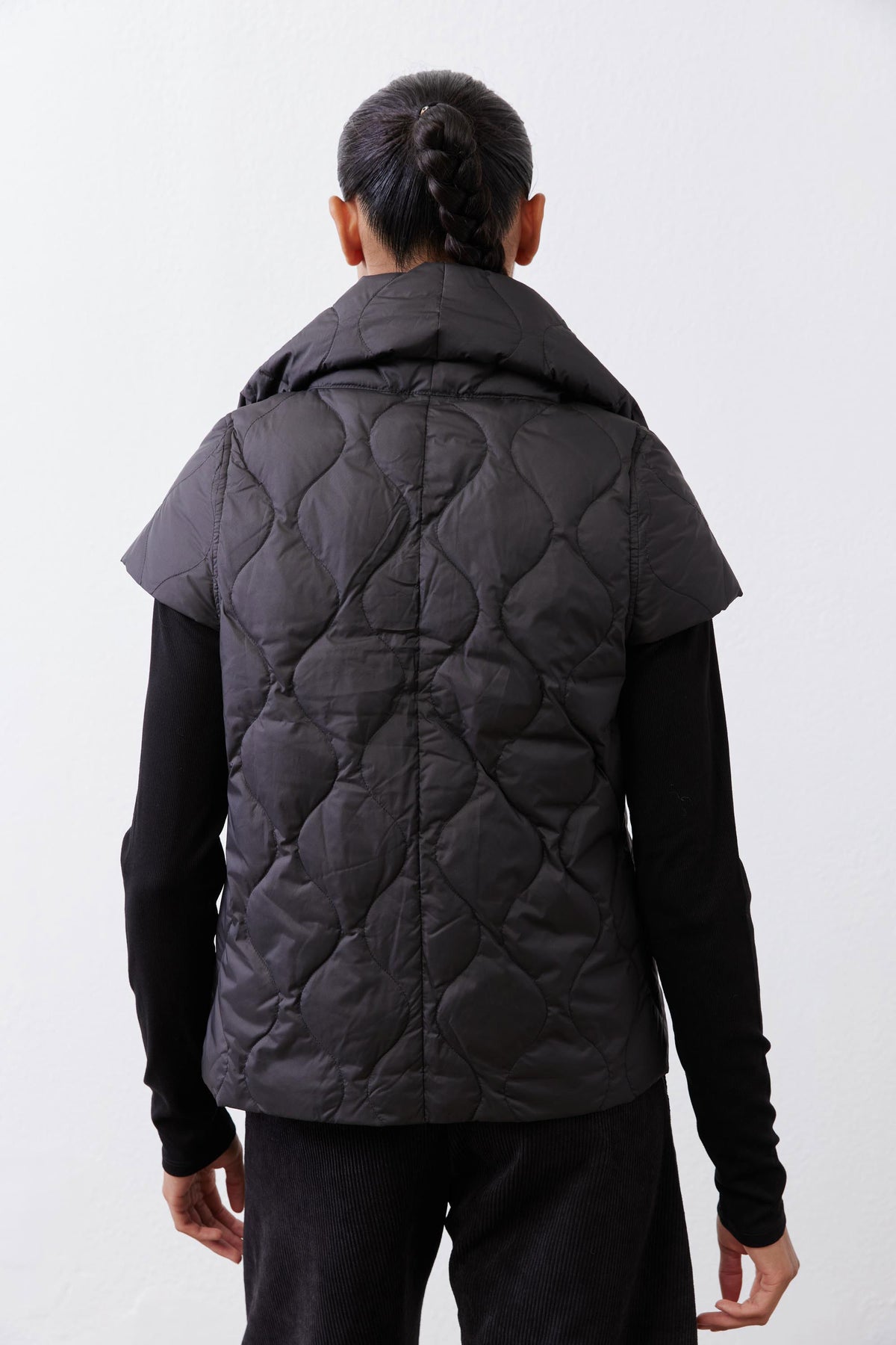 Black quilted down vest back view with stand collar